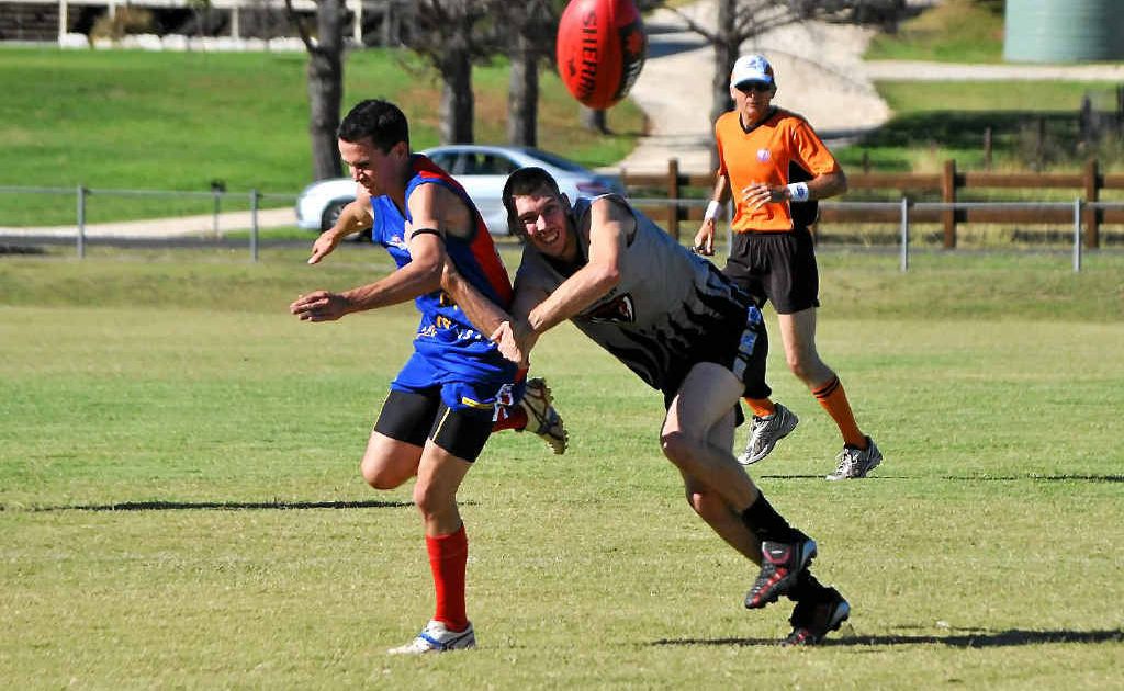 Redbacks player Matt Sinkins narrowly avoids being tackled by Demons player Luke Monk. Redbacks player Matt Sinkins narrowly avoids being tackled by Demons player Luke Monk.